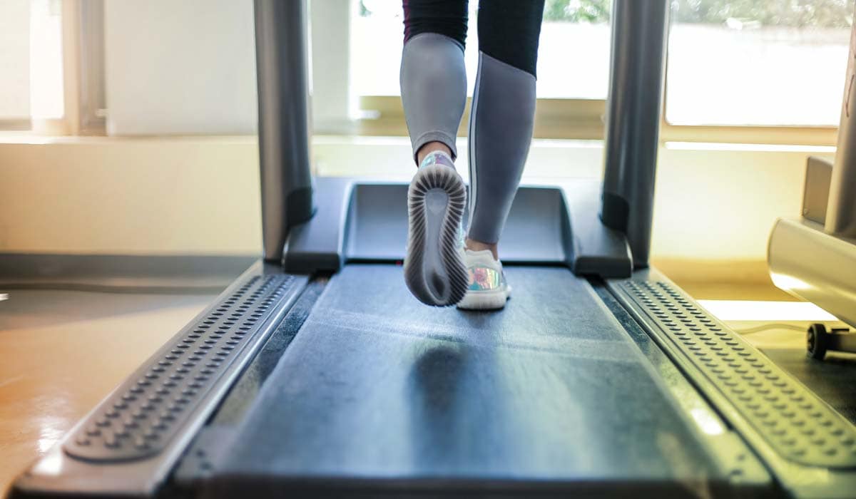 woman runs on a treadmill