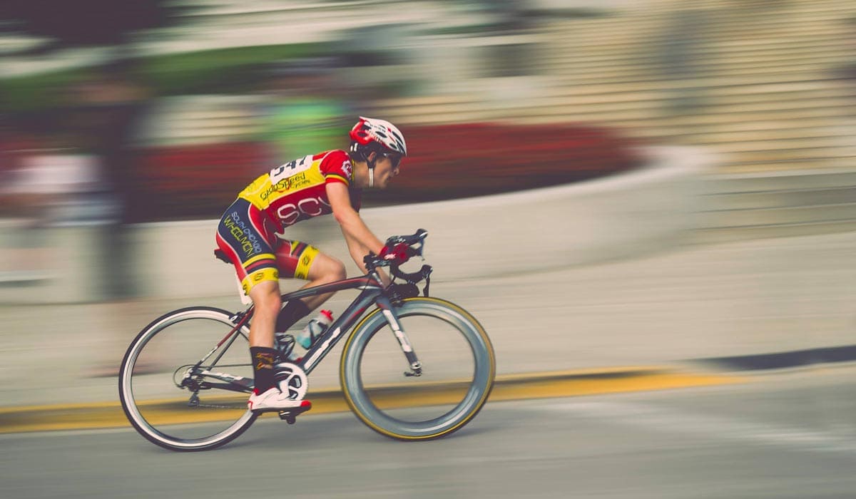 View of a cyclists going really fast around the corner. 