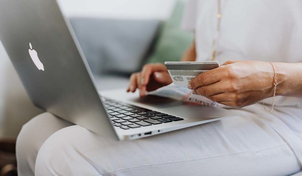woman with a credit card on her computer