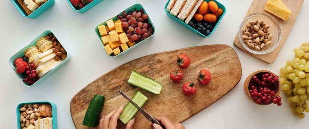 Woman Cutting Healthy Foods on a Cutting Board