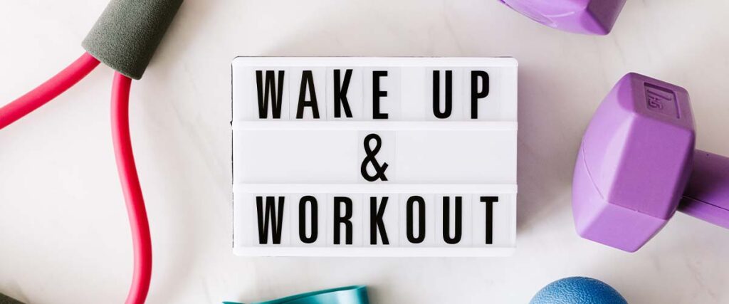 Sign with Wake Up & Workout" Next to Weights and Jump Rope