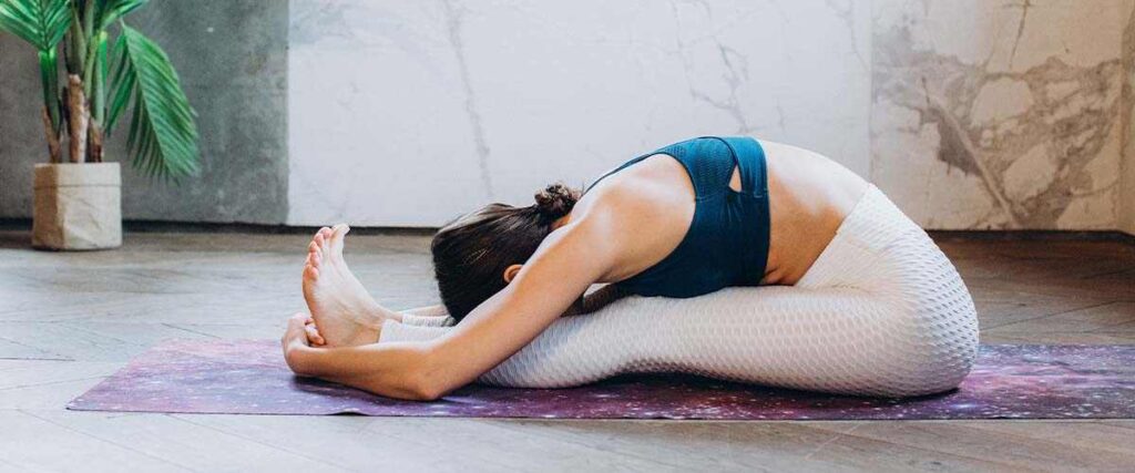 Woman Doing Yoga on Yoga Mat at Home