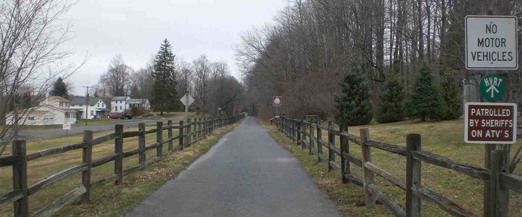 Great Lakes Seaway Trail paved path with wooden fence