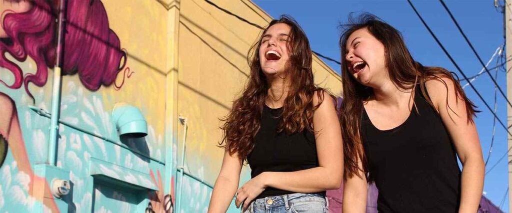 Two young women laughing.