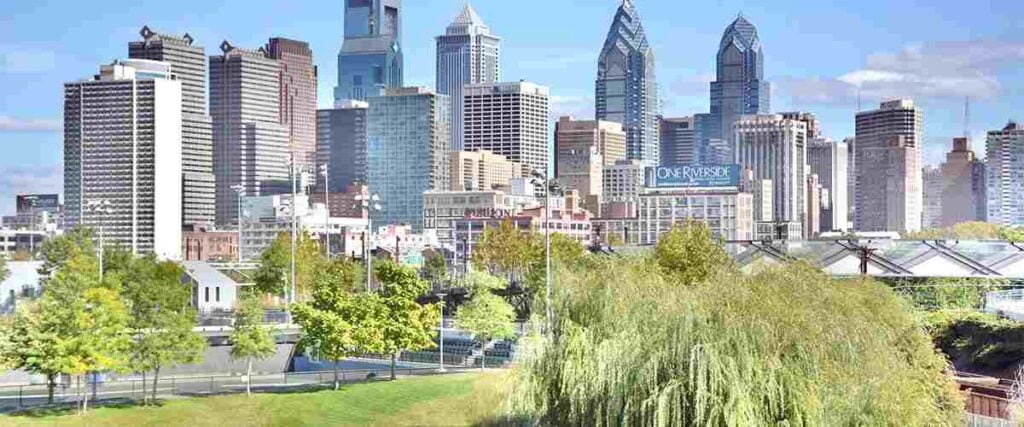 Philadelphia skyline taken from the South Street Bridge, showing Penn Park in the foreground