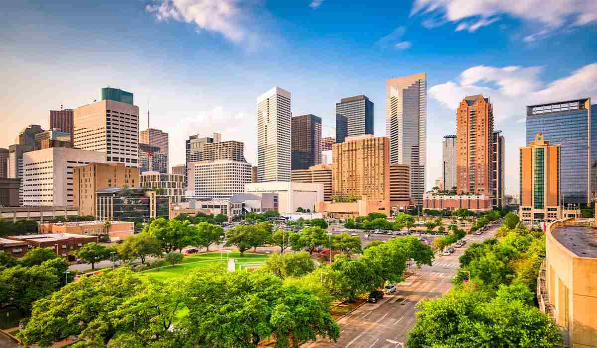 Downtown Houston skyline during the day with bright blue skies.