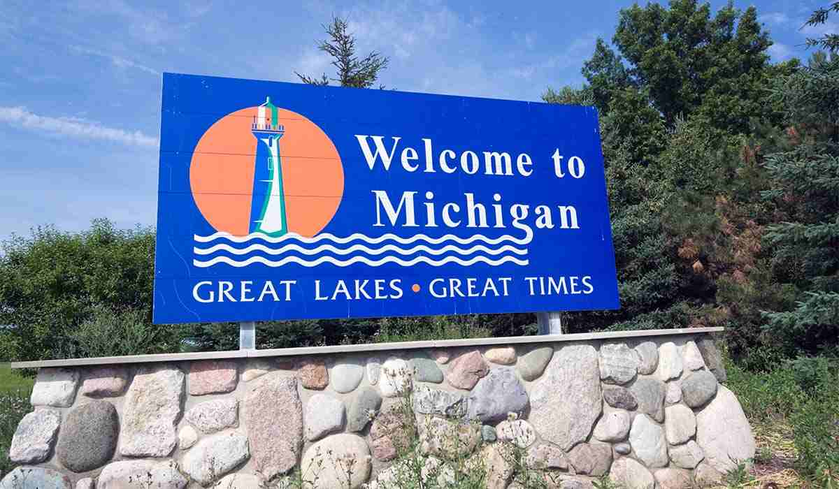 Welcome sign into the state of Michigan on the side of the road. 