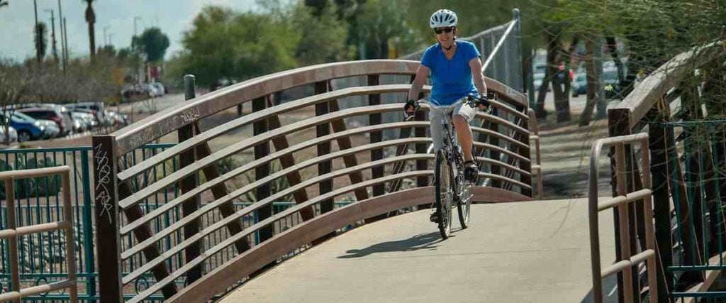 Cyclists on paved path on the New River Trail - Glendale to Peoria, AZ.