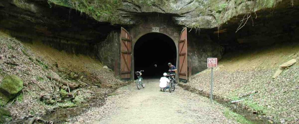 Two bikers fixing their bikes on the Elroy-Spartra tail next to old rail-way.