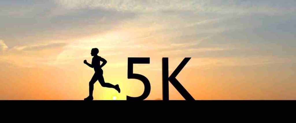 A man running against the sunset with '5k' next to him!