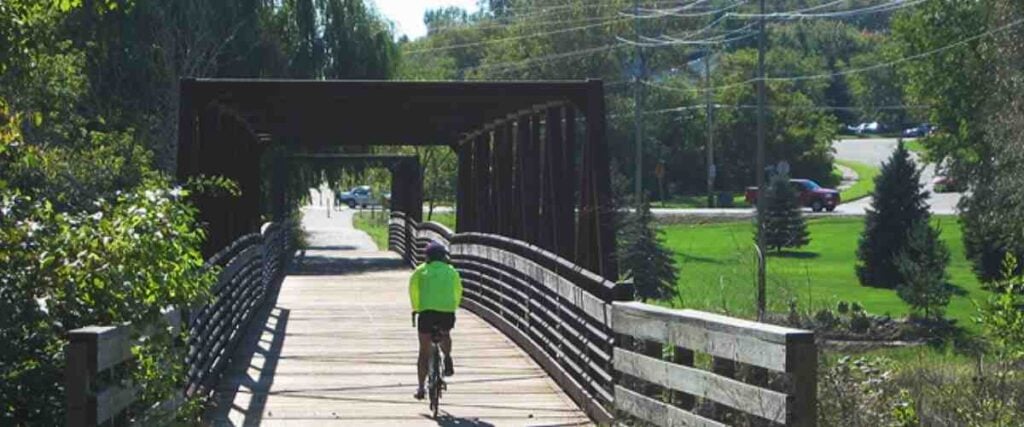 View of cyclists on bridge on Ozaukee Interurban Trail. 