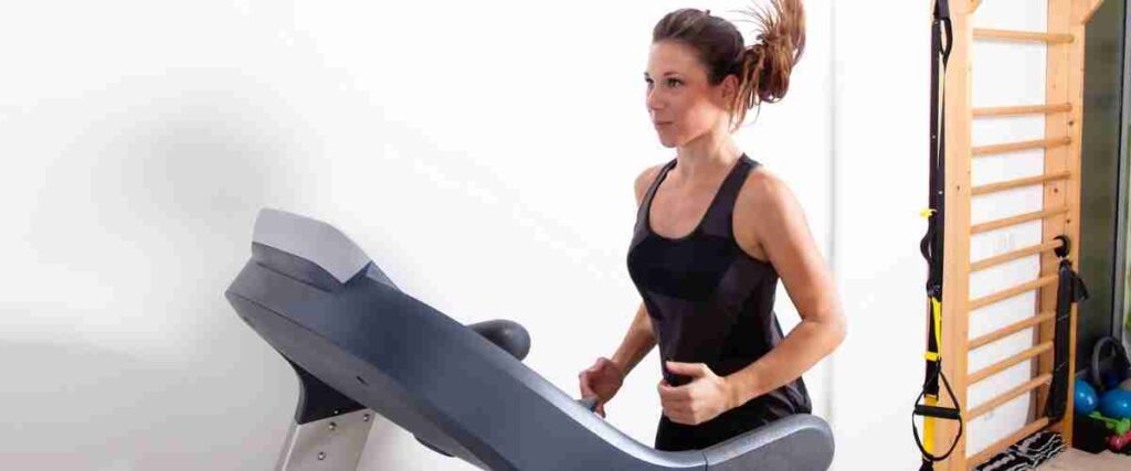 Woman running on her treadmill in her home gym.