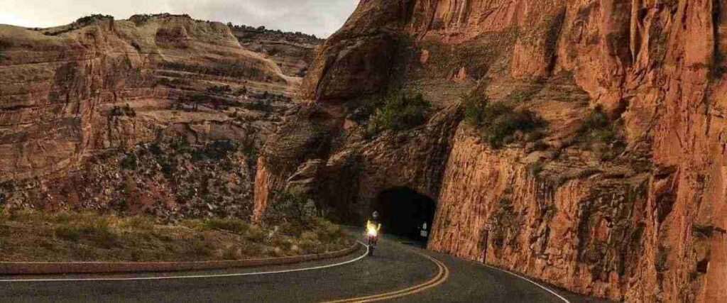 Cyclist about to ride through a tunnel in the Colorado National Monument park.