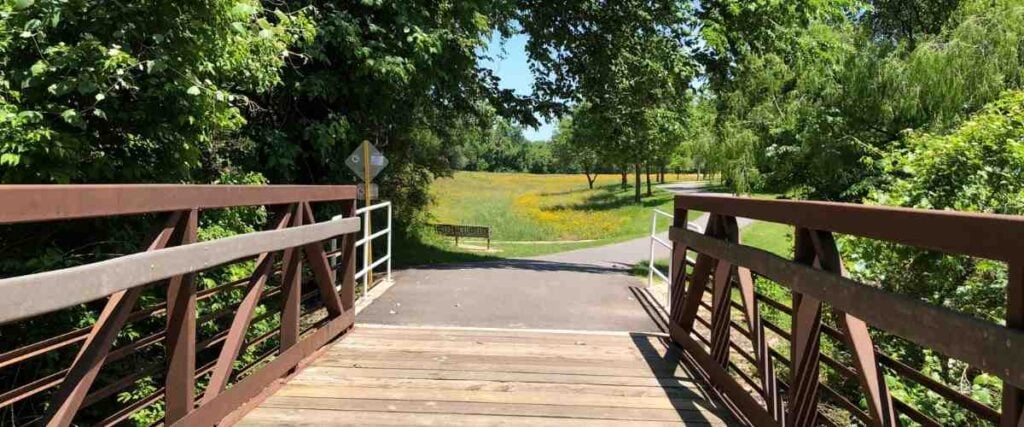 View of bridge connecting to bike path. 