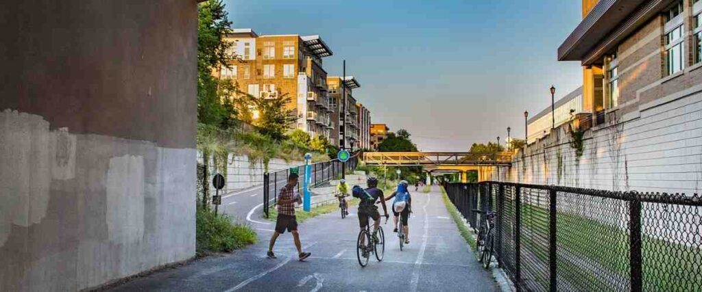 Cyclists and walker at dusk on bike trial. 