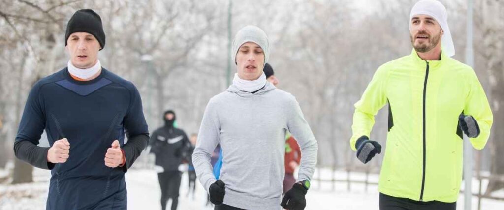 Group of men running outside during the winter.