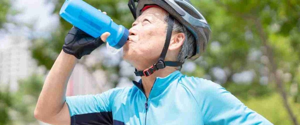 Male cyclist drinking out of his water bottle. 