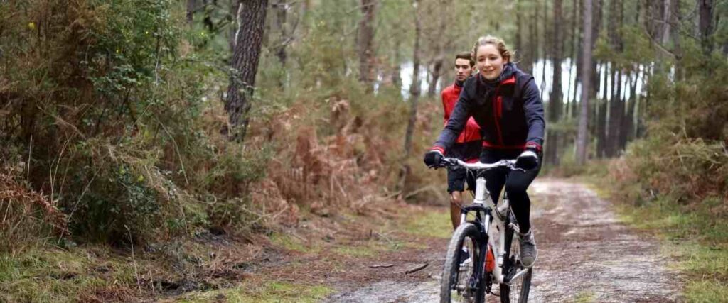 A couple in the forest exercising together.