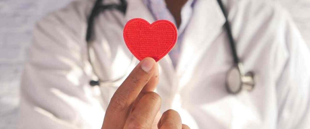 Doctor holding a red velvet heart. 