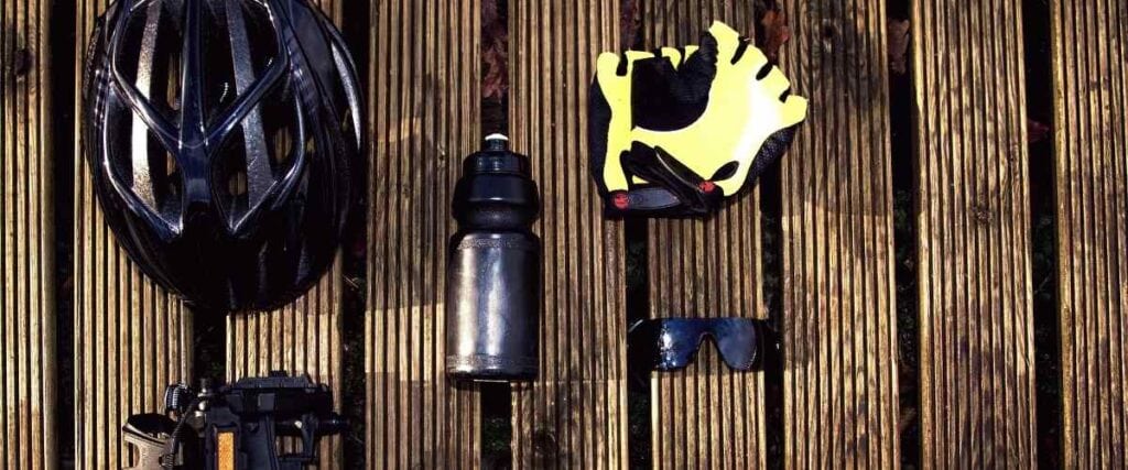 Cycling gear laid out on wooden floor.