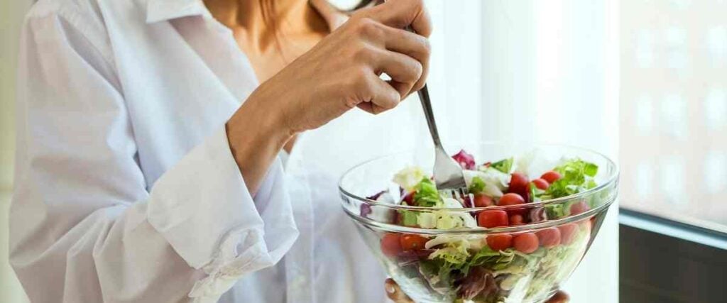 A woman eating a healthy salad. 
