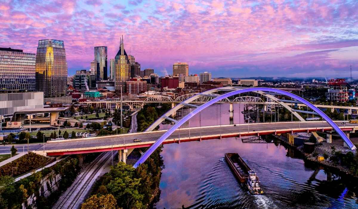 View of downtown Nashville at night with a beautiful purple sky. 