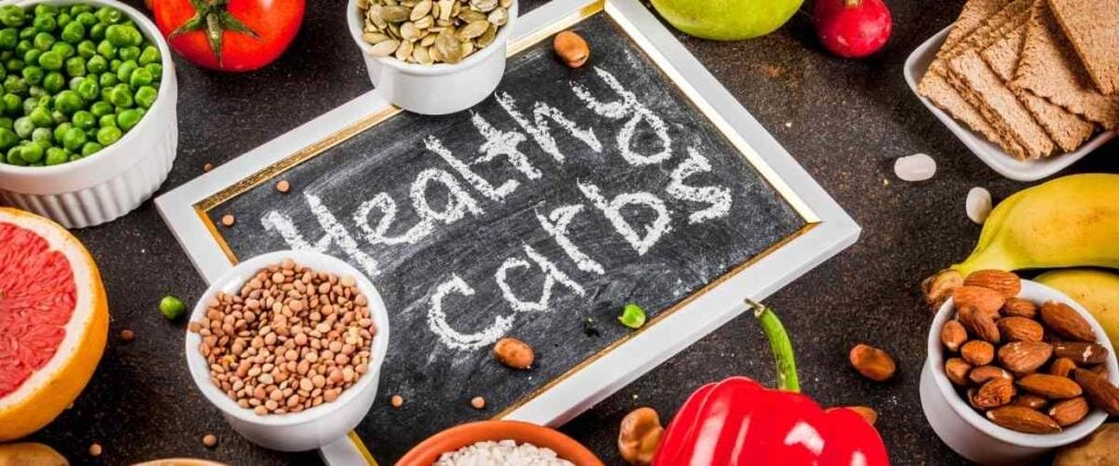 Chalk board with "Healthy Carbs" written on it, with carbs around it. 