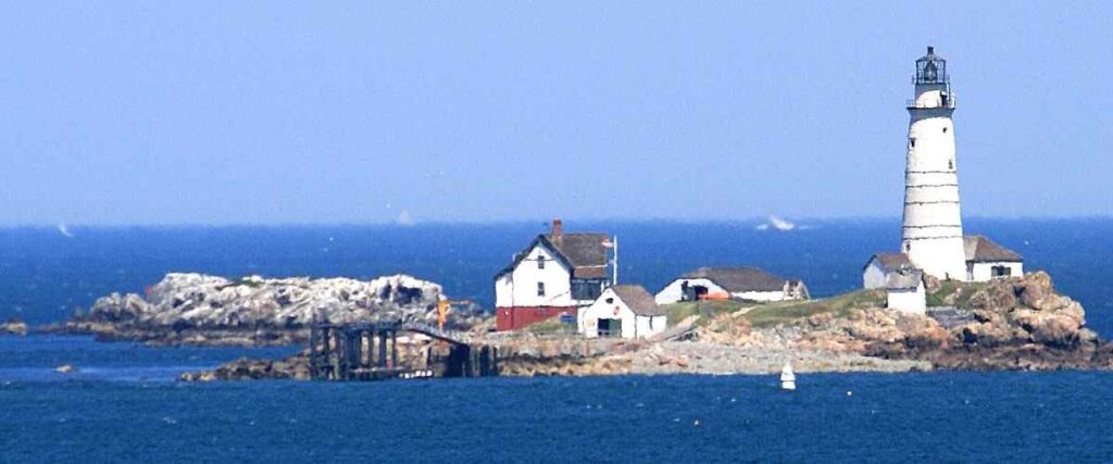 The lighthouse and houses on an island on the Boston Harbor Islands National Park.