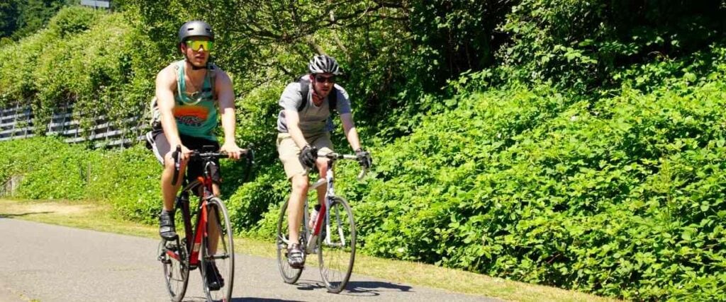 Two cyclists on paved trail.