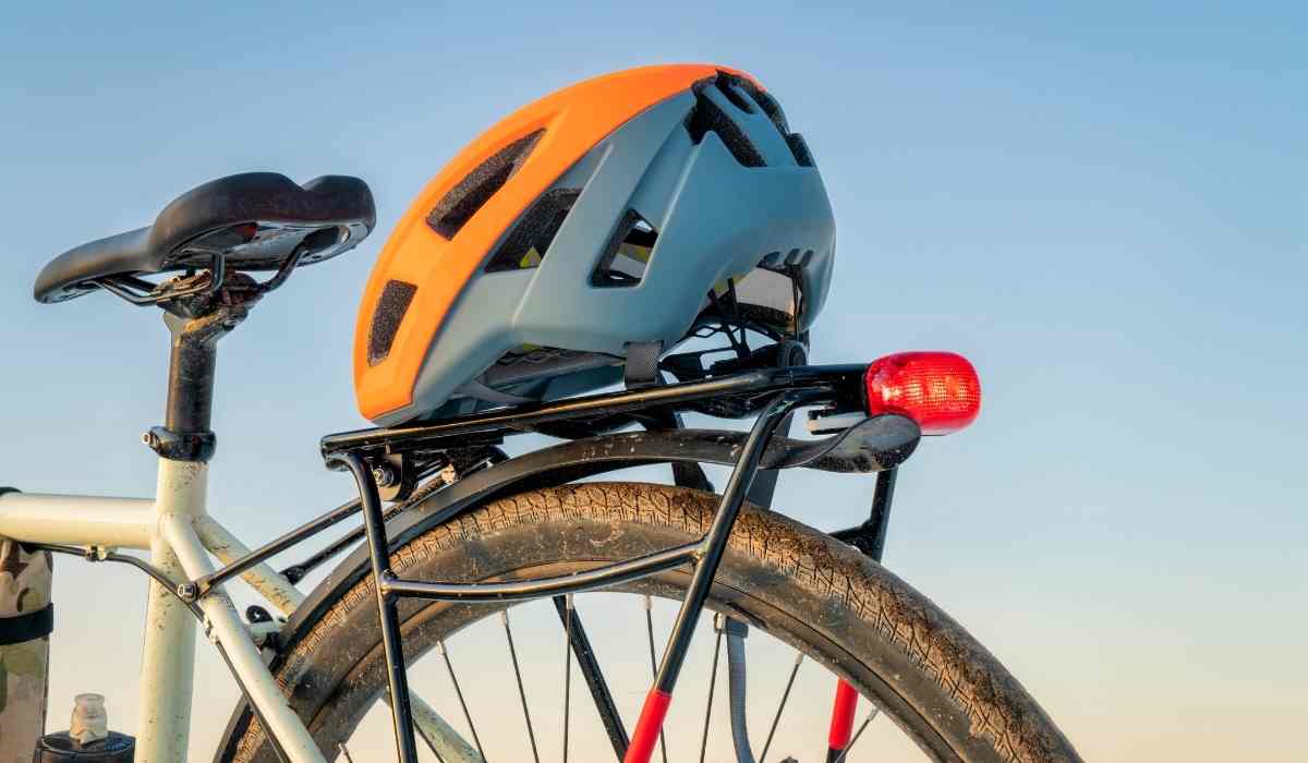 View of helmet on the back of his bike.