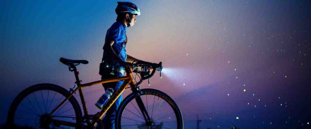 A cyclists using a bike light at night.