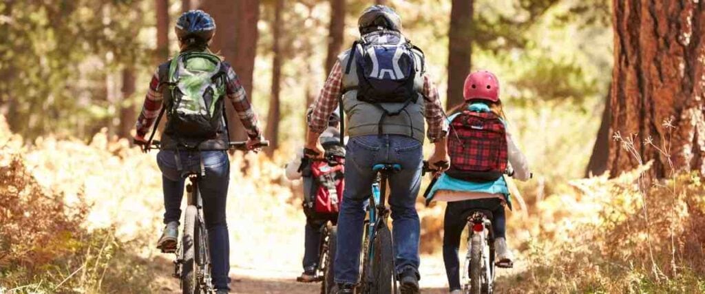 Family of cyclists on a trail.