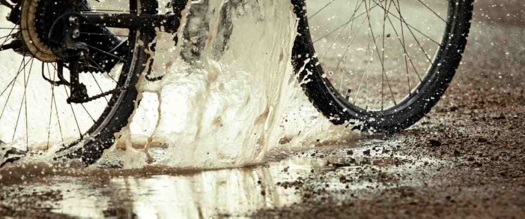 Bike tires going thru big water puddle.