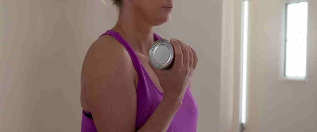 Woman using soap cans as weights.