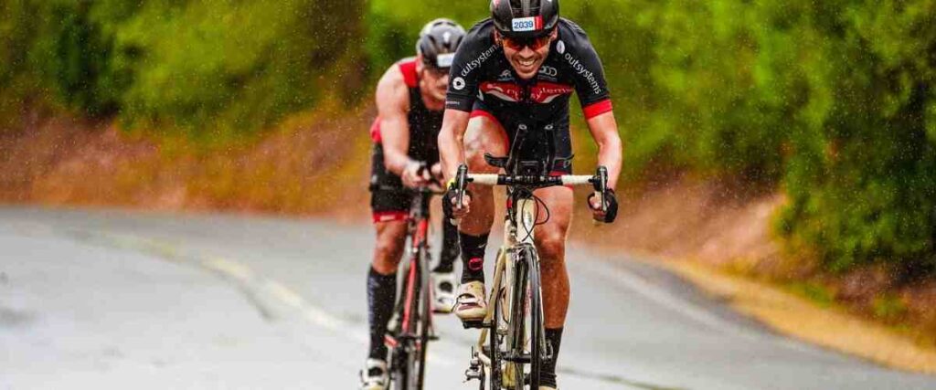 Two cyclists in the middle of a rain storm. 
