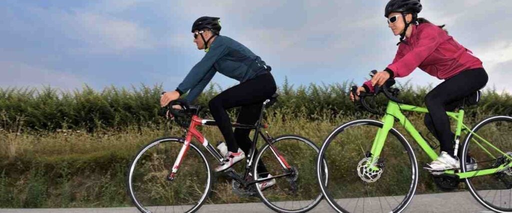 Cyclists wearing layers of clothes to stay warm.