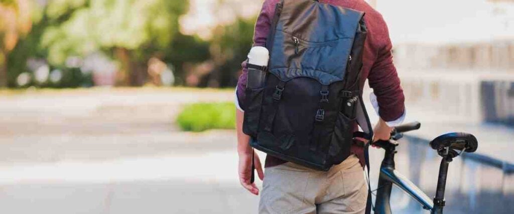 Cyclists in work clothes with waterproof backpack.