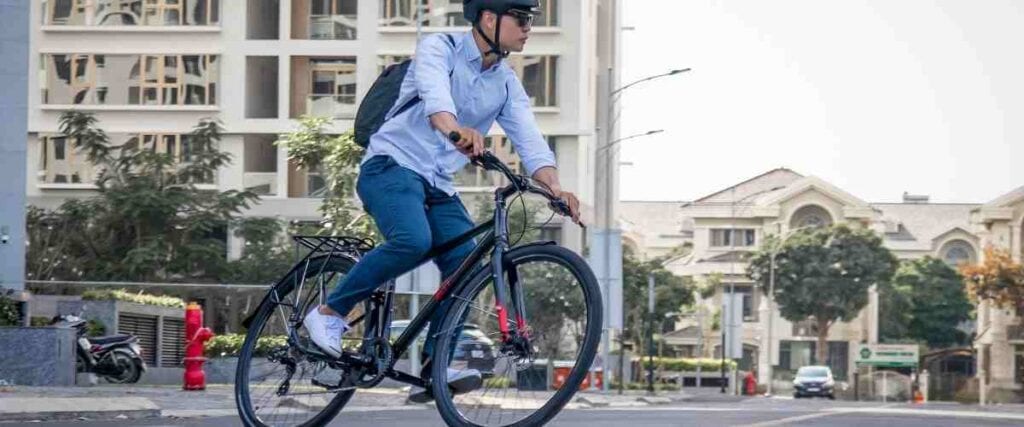 Male cyclists in city taking a turn.