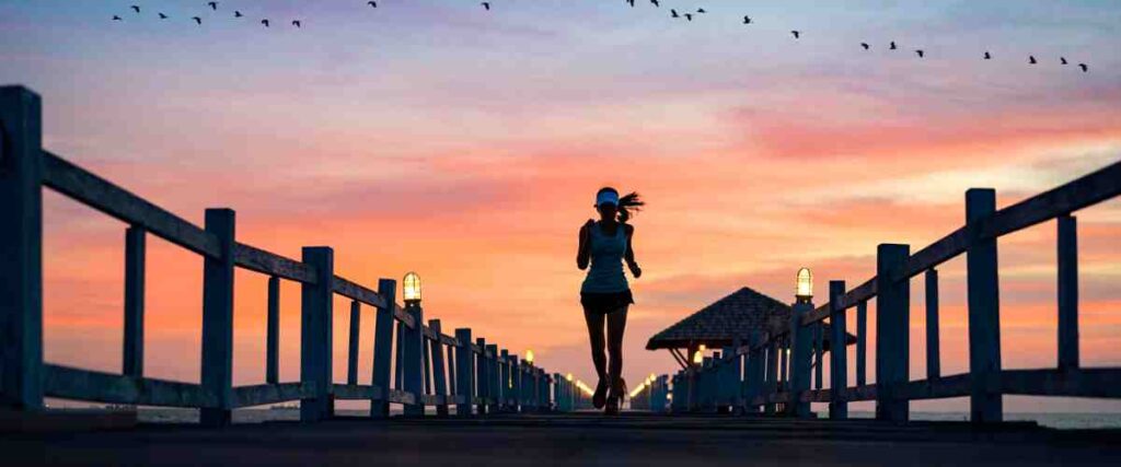 Woman running on bridge during dusk.