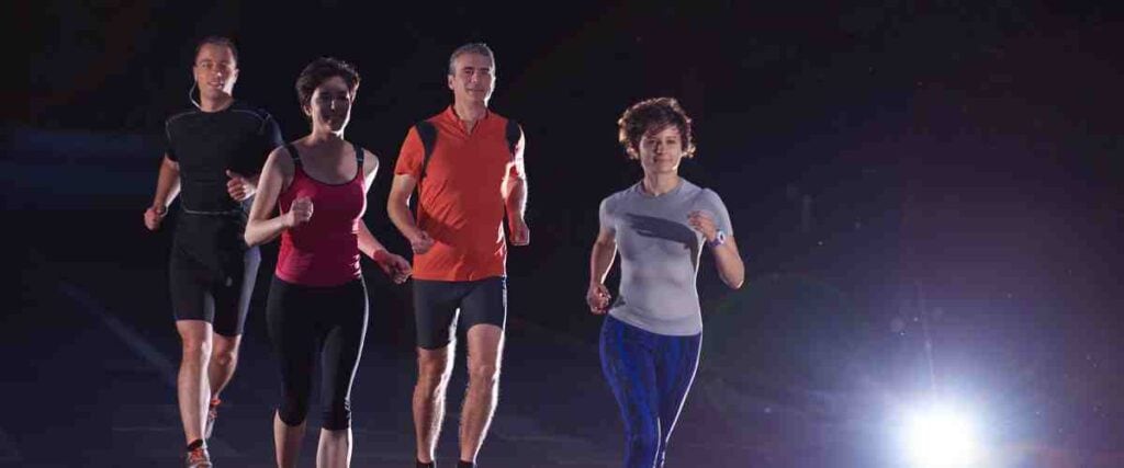 Group of runners at night.