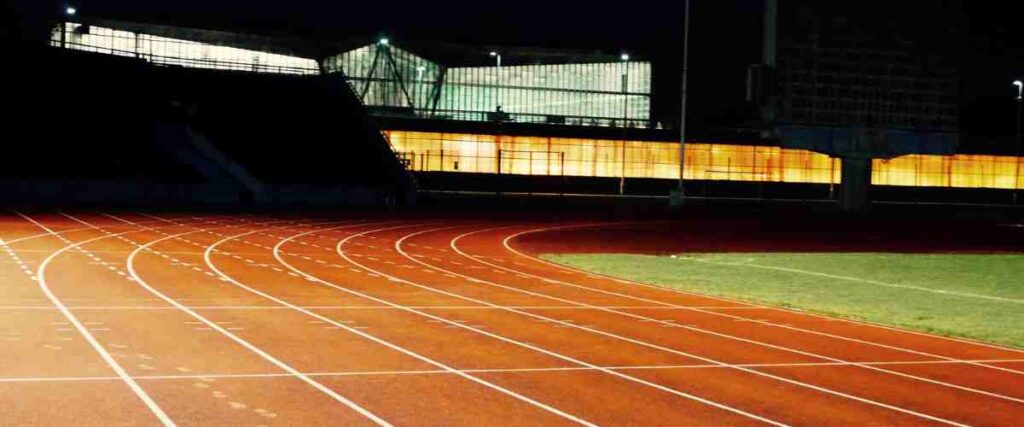 A track field at night.