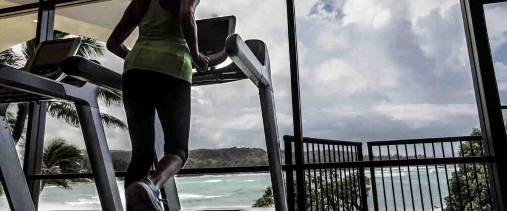 Woman on treadmill with view of the ocean. 