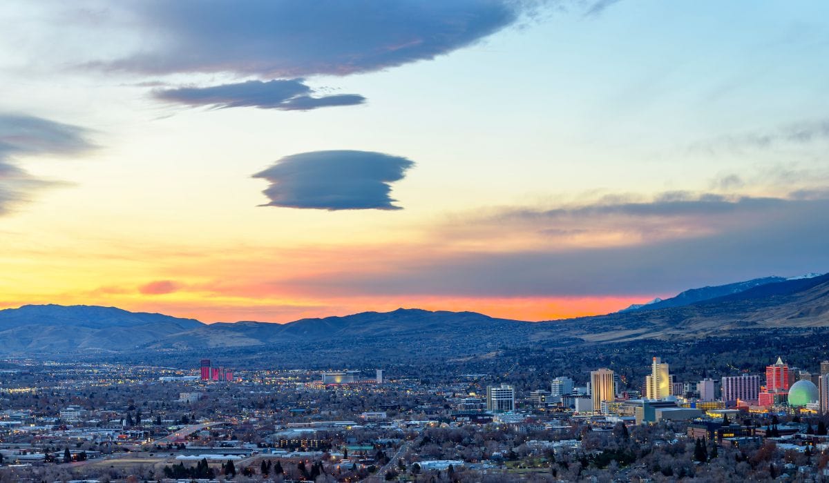 Beautiful aerial view of Las Vegas during the sunset with the backdrop of the hills and the sky in various blues and oranges.