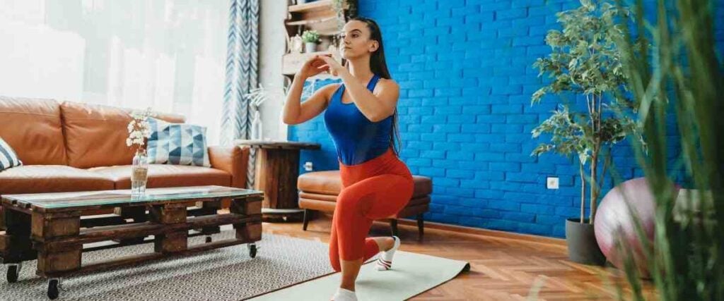 Woman doing yoga in her living room. 