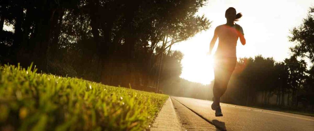 A woman running at sun set. 