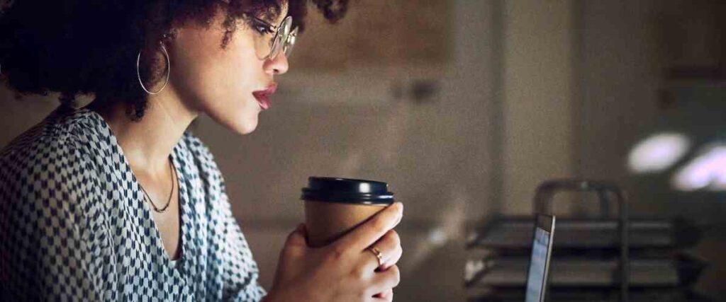 Woman working late drinking coffee.