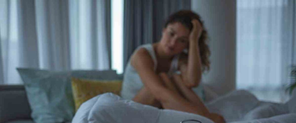 Woman can't sleep looking upset. 