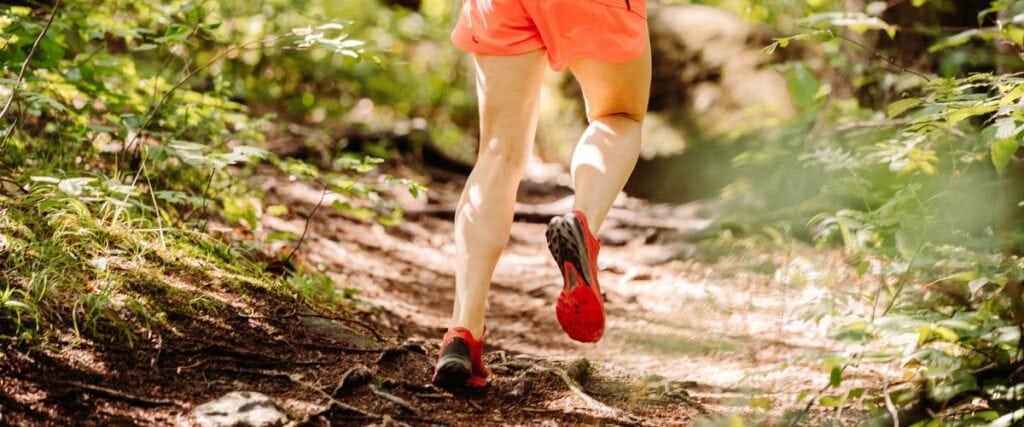 A male runner on a forest path. 