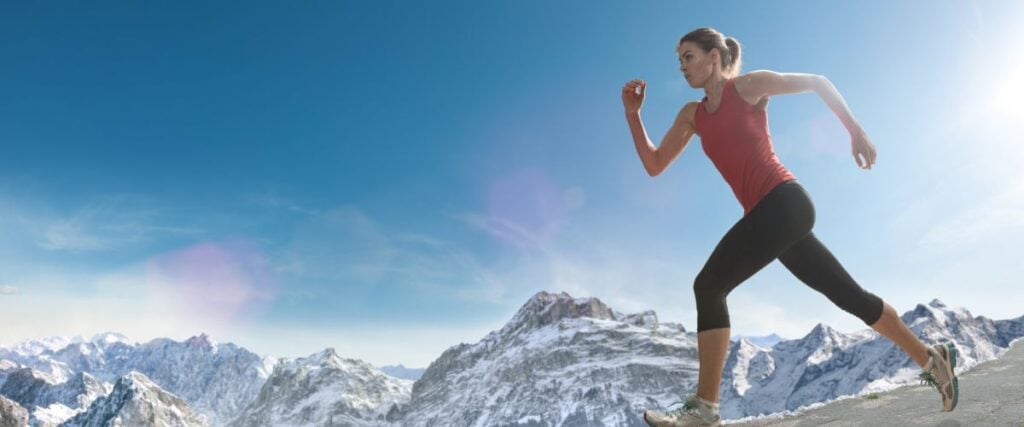Woman running in the mountains. 