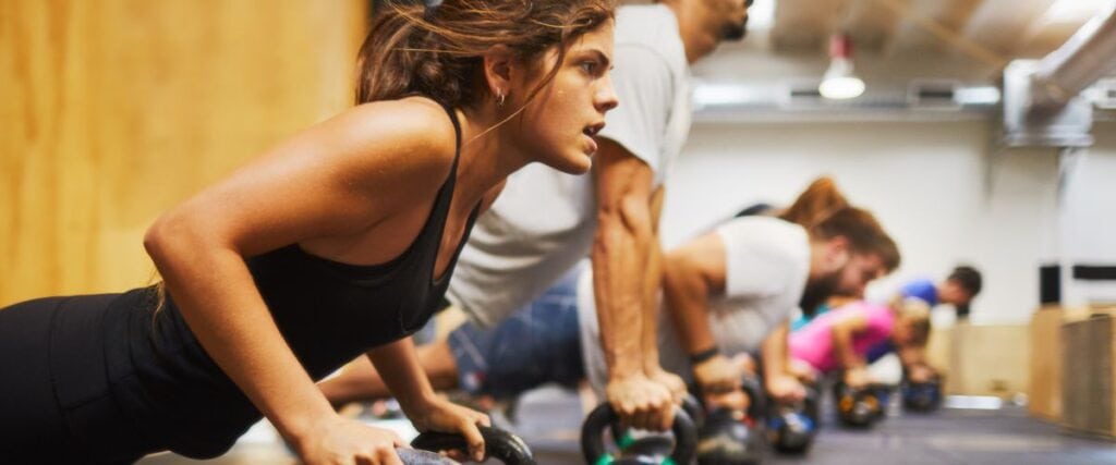 A group of people doing weights in a fitness class. 